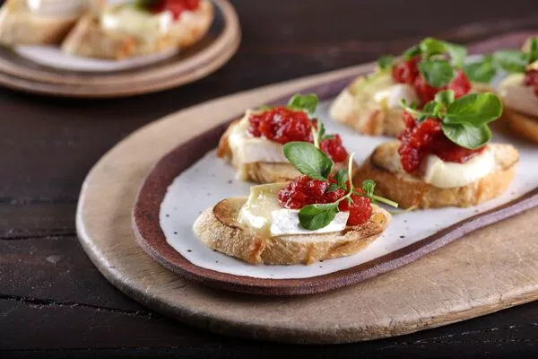 Brie Crostini Topped with Tomato Jam and Balsamic Syrup